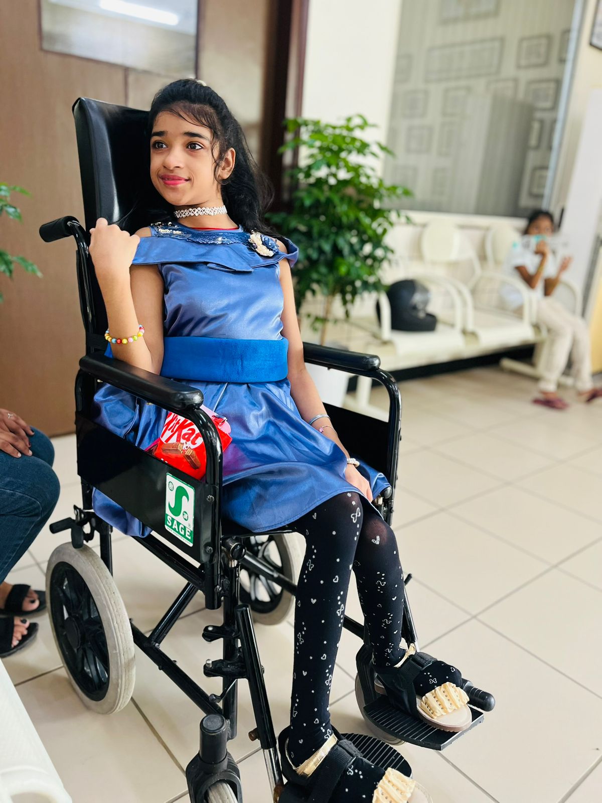 Aaradhya, Saloni's daughter, smiling in her wheelchair